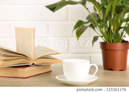 Working table with coffee cup, books and houseplant. Stay home 115561179