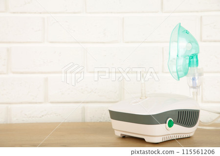 Compressor nebulizer with mask on table. Top view Compressor nebulizer with mask on table. Top view 115561206