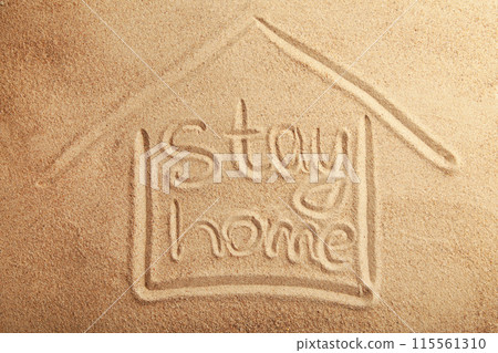 The inscription stay home on the sandy beach. Top view The inscription stay home on the sandy beach. Top view 115561310