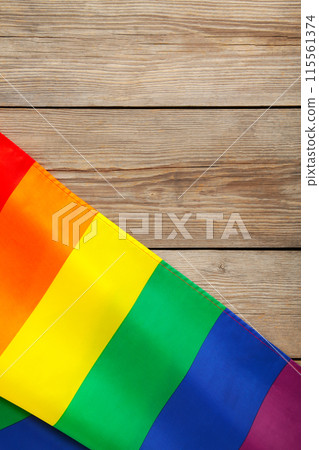 Rainbow LGBT flag on grey wooden background with copy space. Vertical foto Rainbow LGBT flag on grey wooden background with copy space. Vertical foto 115561374