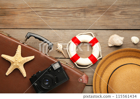 Vintage suitcase and beach accessories on grey background 115561434