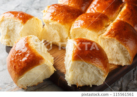 Sweet Hawaiian Bread Rolls for sandwiches, or just to snack on on their own closeup on the wooden board. Horizontal 115561561