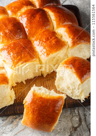 Homemade Hawaiian Rolls bread soft and fluffi closeup on the wooden board. Vertical Homemade Hawaiian Rolls bread soft and fluffi closeup on the wooden board. Vertical 115561564