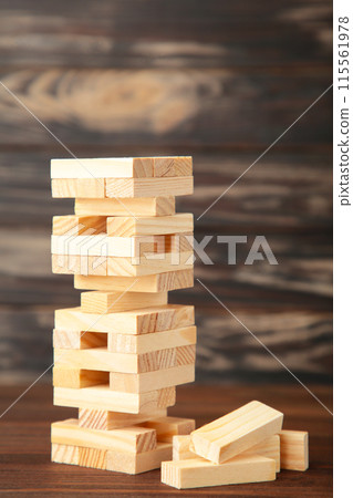 Blocks of wood on brown background. Tower 115561978