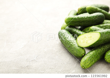 Many harvest cucumbers on the grey concrete background with copy 115561992