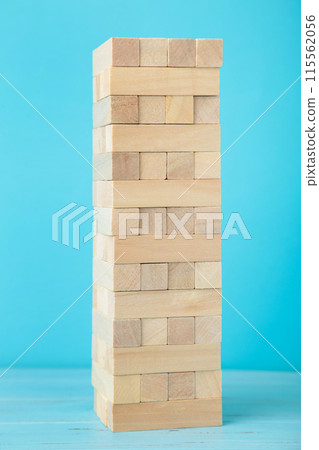 Blocks of wood on blue background. Tower Blocks of wood on blue background. Tower 115562056