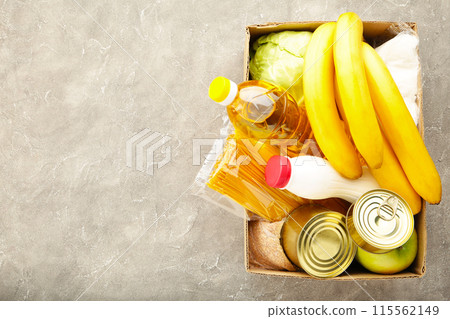 Food donations on grey concrete background. Top view Food donations on grey concrete background. Top view 115562149