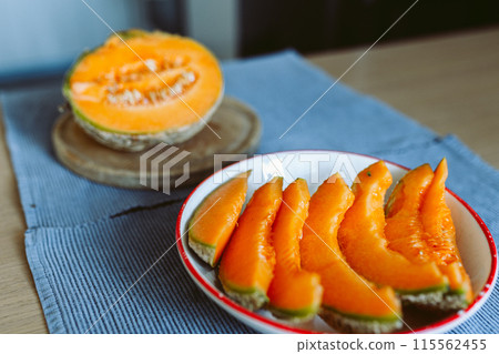 ripe melon cut on a plate ripe melon cut on a plate 115562455