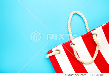Summer bag on blue background. Beach accessories 115564039