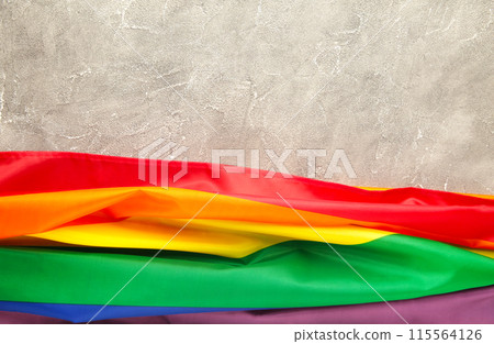 Rainbow LGBT flag on grey concrete background with copy space 115564126