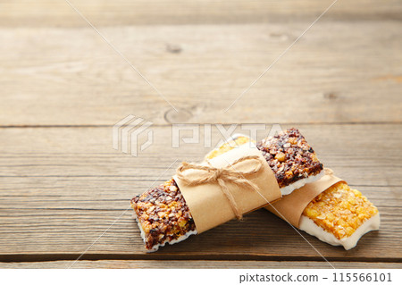 Energy bars - snack for healthy still life with copy space on grey background. Energy bars - snack for healthy still life with copy space on grey background. 115566101