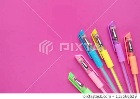 Set of colored pens on pink paper background with copy space Set of colored pens on pink paper background with copy space 115566629