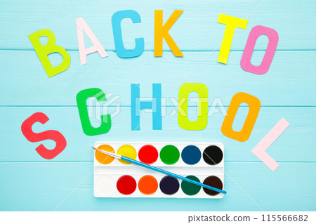 Watercolor paints set with inscription back to school on blue background 115566682