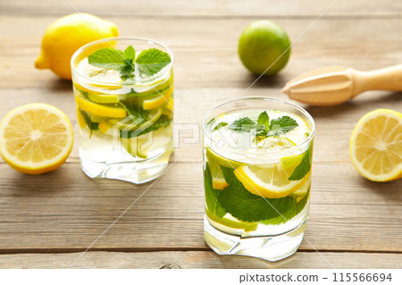 Cold fresh lemonade drink on a grey wooden background Cold fresh lemonade drink on a grey wooden background 115566694