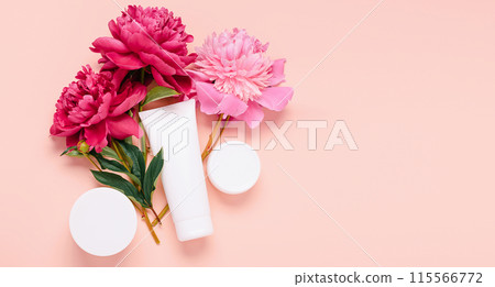 Cosmetic products cream gel shampoo balm in various bottles on a pink background with fresh flowers peonies 115566772