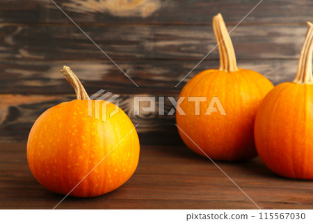 Fresh orange pumpkin on brown wooden background 115567030