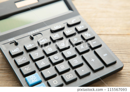 Calculator on grey wooden background, macro foto Calculator on grey wooden background, macro foto 115567093