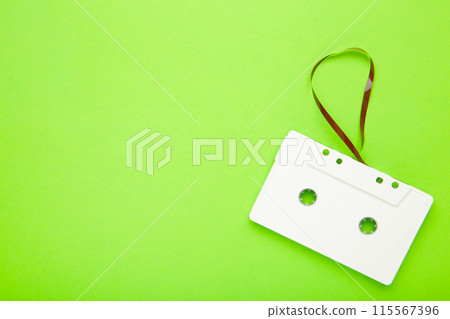One old white cassette on a green background. Music day 115567396