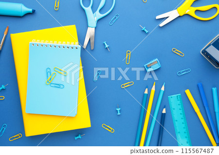 School supplies on blue background. Back to school. Flat lay. School supplies on blue background. Back to school. Flat lay. 115567487