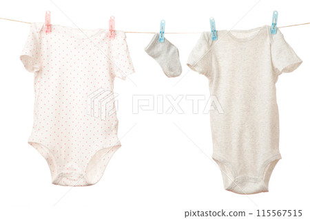 Baby clothes hanging on the clothesline isolated on white. Baby clothes hanging on the clothesline isolated on white. 115567515