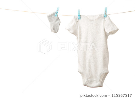 Baby clothes hanging on the clothesline isolated on white. 115567517