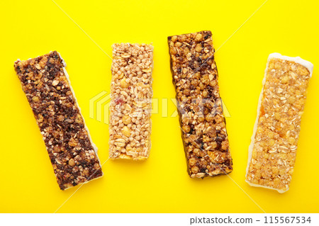 Energy bars - snack for healthy still life on yellow background. Energy bars - snack for healthy still life on yellow background. 115567534