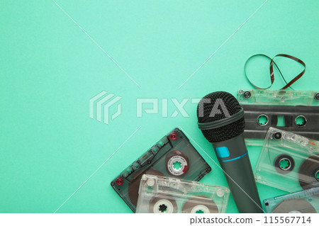 Microphone and cassette on mint background with copy space 115567714