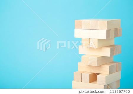 Blocks of wood on blue background. Tower Blocks of wood on blue background. Tower 115567760