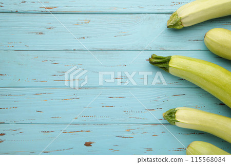 Fresh organic zucchini on the blue wooden table. Fresh squash Fresh organic zucchini on the blue wooden table. Fresh squash 115568084