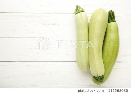 Fresh organic zucchini on the white wooden table. Fresh squash 115568086