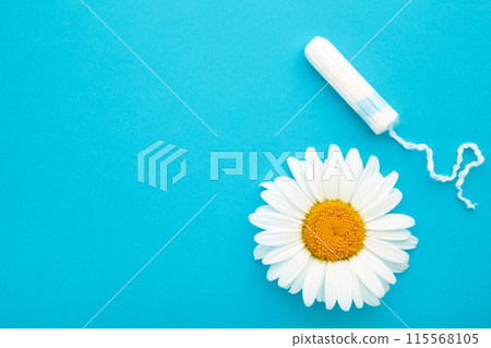 Medicinal chamomile flower and menstrual sanitary tampon. Woman critical days, gynecological menstruation cycle. 115568105