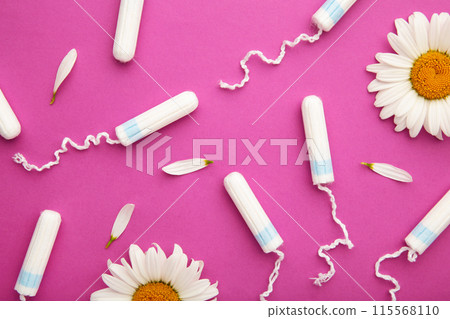 Medicinal chamomile flower and menstrual sanitary tampon. Woman critical days, gynecological menstruation cycle. 115568110