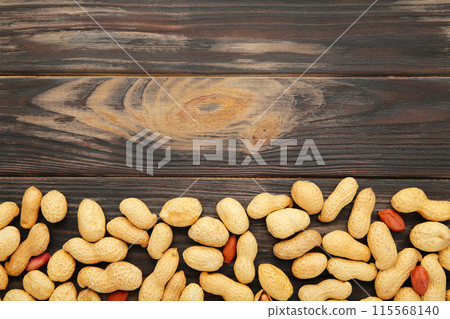 Peanuts in shells on brown background with copy space Peanuts in shells on brown background with copy space 115568140