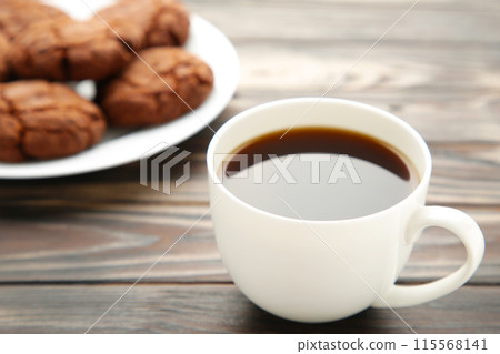 Cup of coffee and chocolate cookies on wooden table Cup of coffee and chocolate cookies on wooden table 115568141