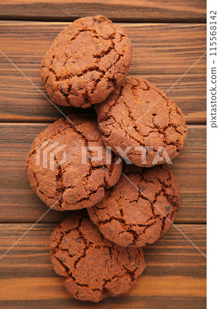 Chocolate chips cookies on brown wooden background Chocolate chips cookies on brown wooden background 115568142