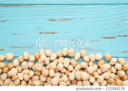 Chickpeas grains on blue wooden background. Top view Chickpeas grains on blue wooden background. Top view 115568176