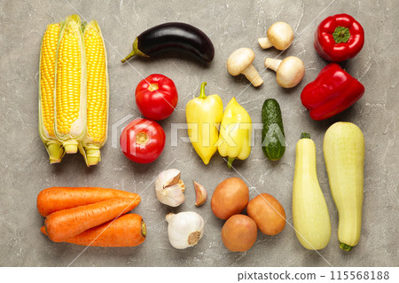 Healthy eating background. Studio photography of different vegetables on grey concrete background Healthy eating background. Studio photography of different vegetables on grey concrete background 115568188