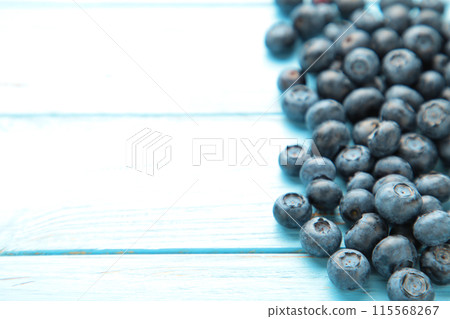 Tasty blueberries on blue background. Blueberries are antioxidant organic superfood. 115568267