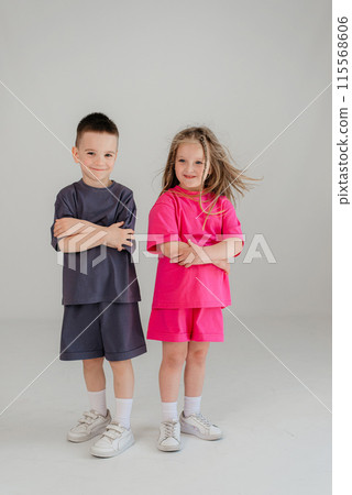 Little couple kids boy girl 4-5 years old have fun isolated on white background children studio portrait. People childhood lifestyle concept Little couple kids boy girl 4-5 years old have fun isolated on white background children studio portrait. People childhood lifestyle concept 115568606