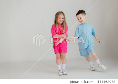 Full length body size view of attractive cheerful kids dancing moving having fun isolated white background Full length body size view of attractive cheerful kids dancing moving having fun isolated white background 115568978