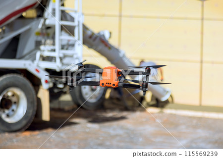 Utilizing drone, contractor supervisor inspects work on job construction site 115569239