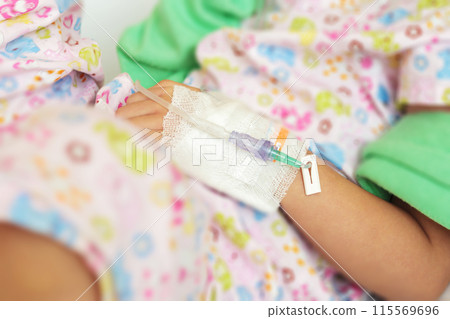 Close up child hand with saline IV solution in hospital 115569696
