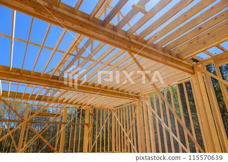Ceiling rafter framework beams were installed during construction of new house Ceiling rafter framework beams were installed during construction of new house 115570639