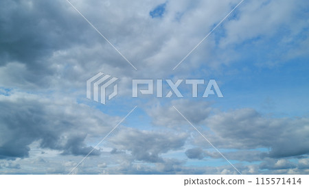 Cloud sky scape. Clouds flying and changing with different shapes on clear blue sky. Timelapse. 115571414
