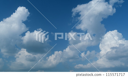 Clouds formation running across the blue sky. White puffy and fluffy layered clouds on blue sky. Timelapse. Clouds formation running across the blue sky. White puffy and fluffy layered clouds on blue sky. Timelapse. 115571717