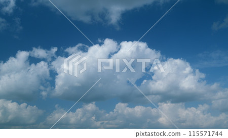 Beautiful blue sky and white cumulus and cirrus on different layers clouds. White cloud like a swan wing high in a blue sky. Timelapse. Beautiful blue sky and white cumulus and cirrus on different layers clouds. White cloud like a swan wing high in a blue sky. Timelapse. 115571744