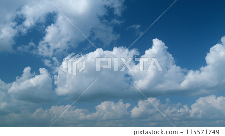 White and gray clouds fly across the sky and change shape. Timelapse. White and gray clouds fly across the sky and change shape. Timelapse. 115571749