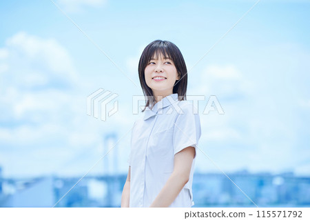 A young lady in a white suit 115571792