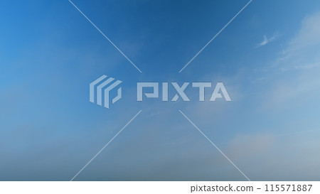 Sky with several layers of clouds moving in different directions. Sun rays at sunshine day. Timelapse. 115571887