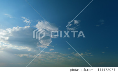 Building clouds and sun rays breaking through cloud mass. Flares shinning through dramatic clouds. Timelapse. 115572071